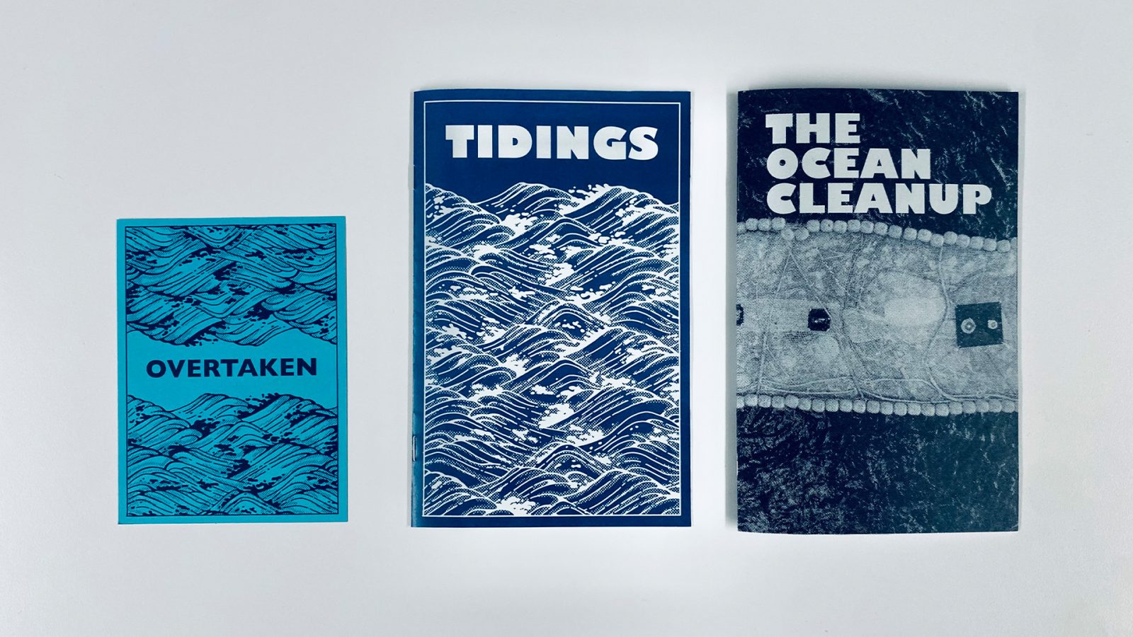 Three covers with blue tones and pattern for Overtaken Zine Package