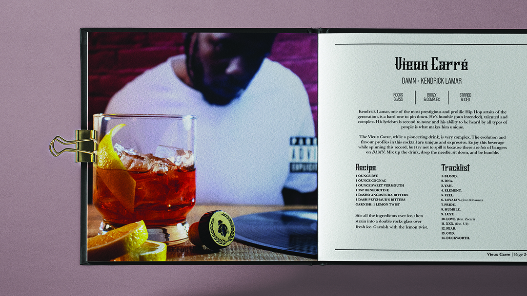 A book held open showing a cocktail paired with a vinyl record and its cover in the background with a cocktail recipe and other text on the opposite page